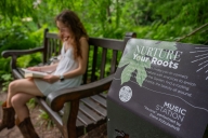 A student reads near a Rooting Station in Beal Botanical Garden at Michigan State University