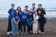 Group of students on beach with matching blue T-shirts