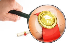 Magnifying glass is held up over a diploma