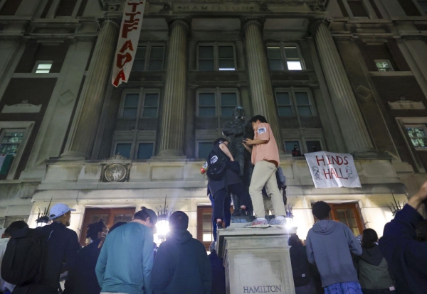 Protesters stand in front of a building they've occupied at Columbia